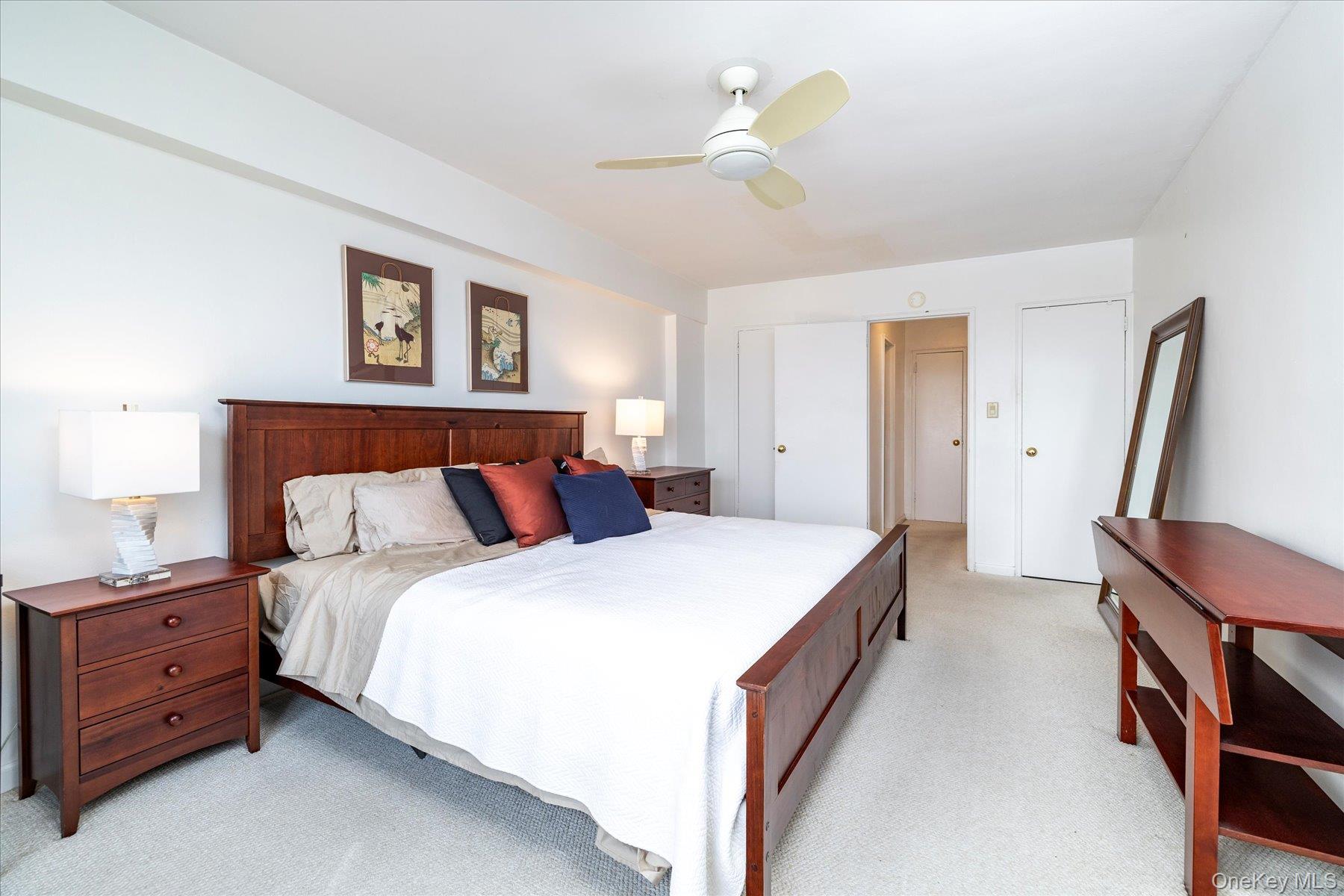 522 Shore Road, Unit 5P Long Beach, NY 11561 - Photo 14 of 28 a bedroom with a bed and a chandelier