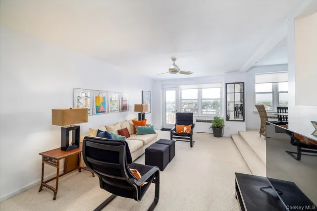 a living room with furniture and a floor to ceiling window