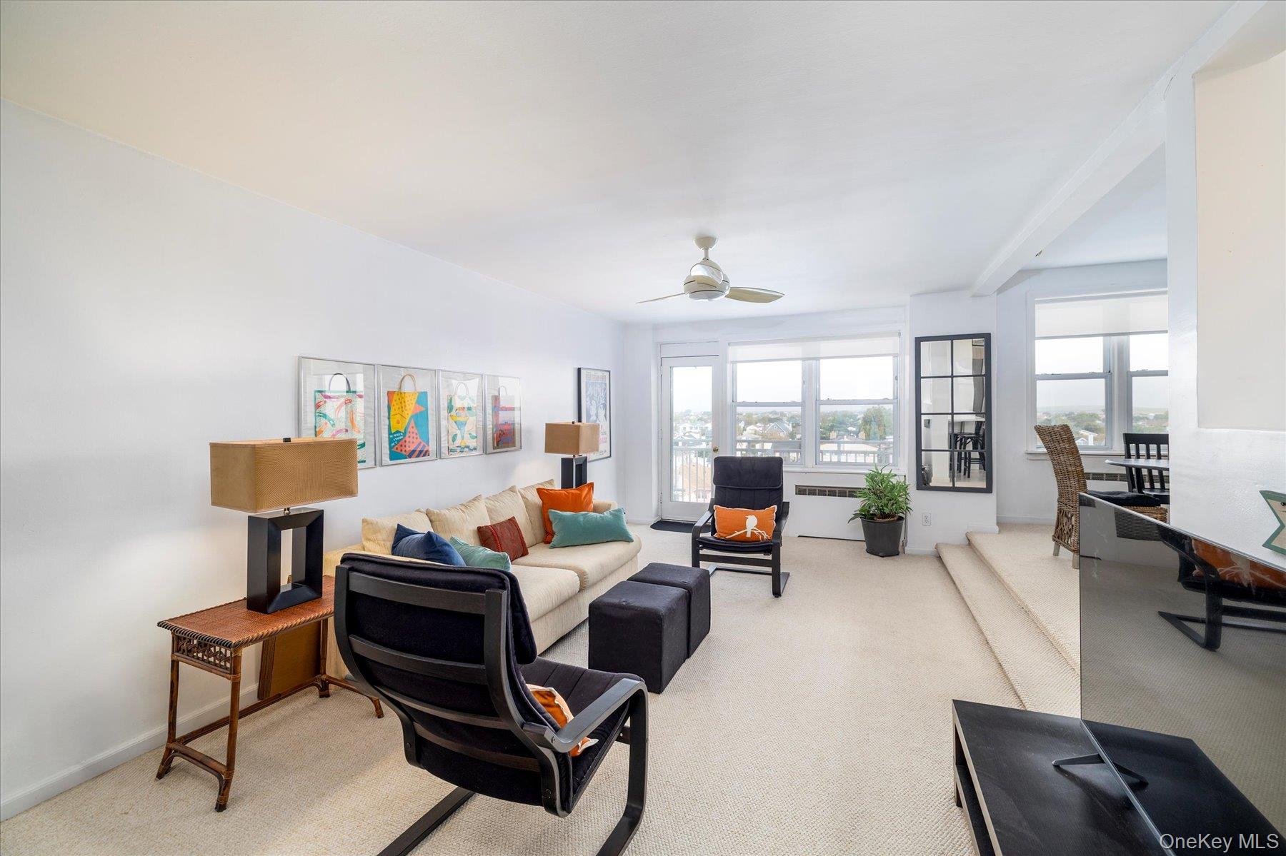 522 Shore Road, Unit 5P Long Beach, NY 11561 - Photo 2 of 28 a living room with furniture and a floor to ceiling window