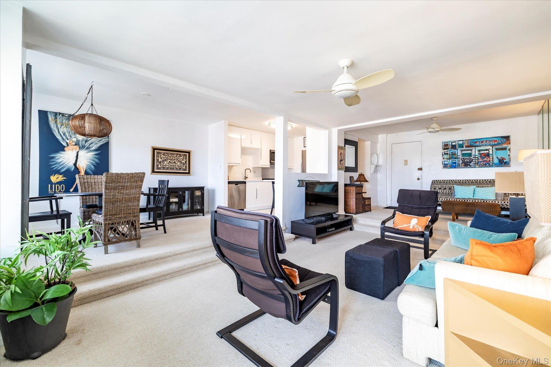 522 Shore Road, Unit 5P Long Beach, NY 11561 - Photo 3 of 28 a living room with furniture a fireplace and a flat screen tv