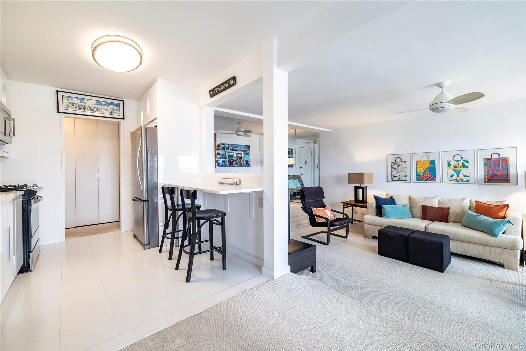 522 Shore Road, Unit 5P Long Beach, NY 11561 - Photo 7 of 28 a living room with furniture and a large window