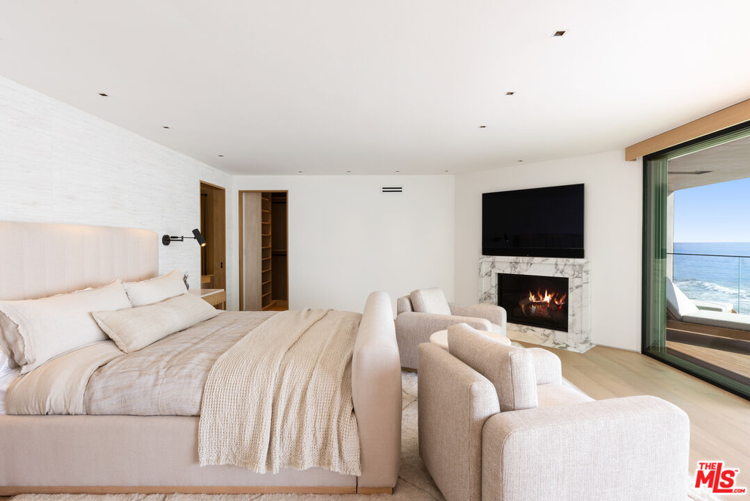 24818 Malibu Road Malibu, CA 90265 - Photo 12 of 23 a bedroom with a bed and a flat screen tv