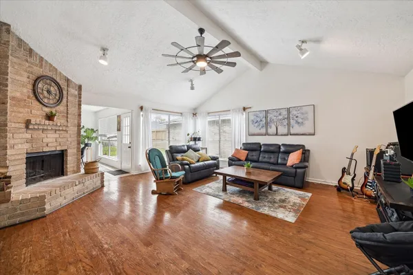 a living room with furniture a fireplace and a flat screen tv
