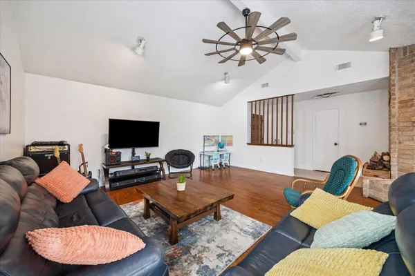 a living room with furniture and a flat screen tv