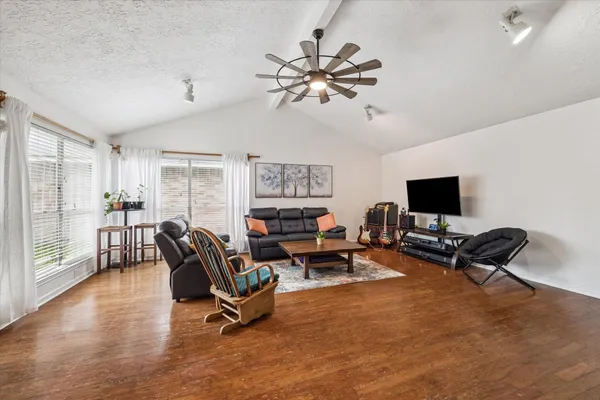 a view of a livingroom with workspace and a window