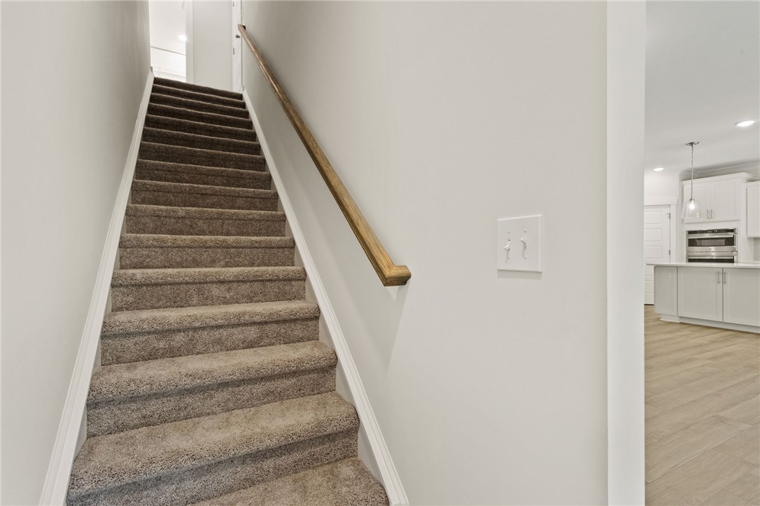 315 Old Shirley Road Central, SC 29630 - Photo 21 of 26 Elegant staircase with plush carpeting leads to the upper level of this inviting home.
