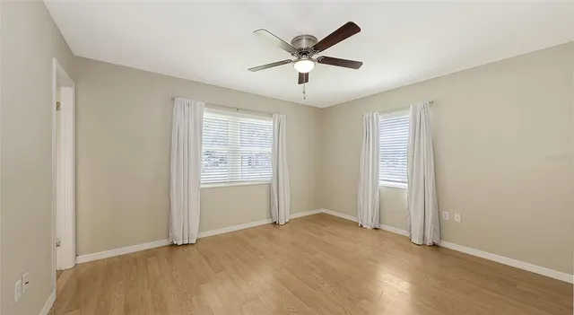 a view of a livingroom with a ceiling fan and window