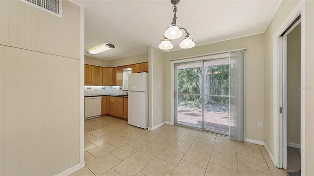 a view of a kitchen with a sink and dishwasher a refrigerator with wooden floor