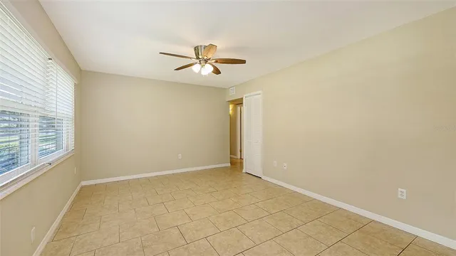 a view of room with hardwood floor and fan