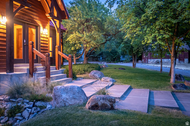435 Canyon Road Millville, UT 84326 - Photo 105 of 113 Wood-sided exterior featuring a covered porch with exposed timber framing and double glass-panel entry doors