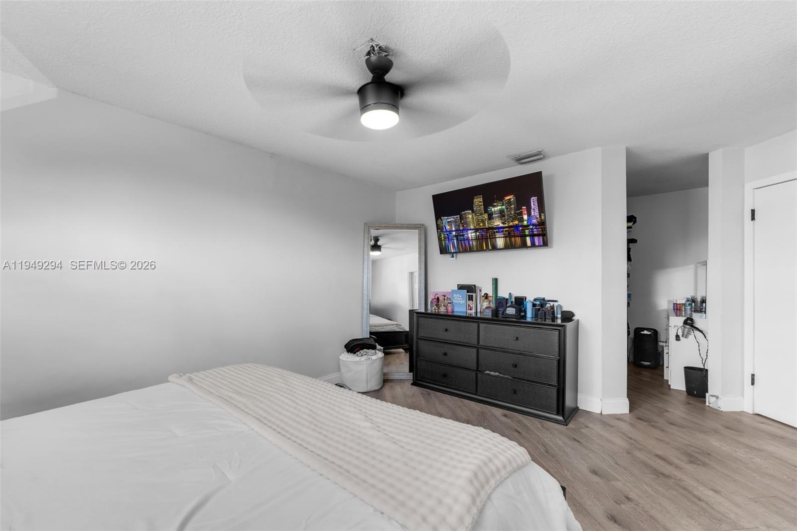 12909 Southwest 64th Lane Miami, FL 33183 - Photo 11 of 35 a bedroom with a bed and a bookshelf