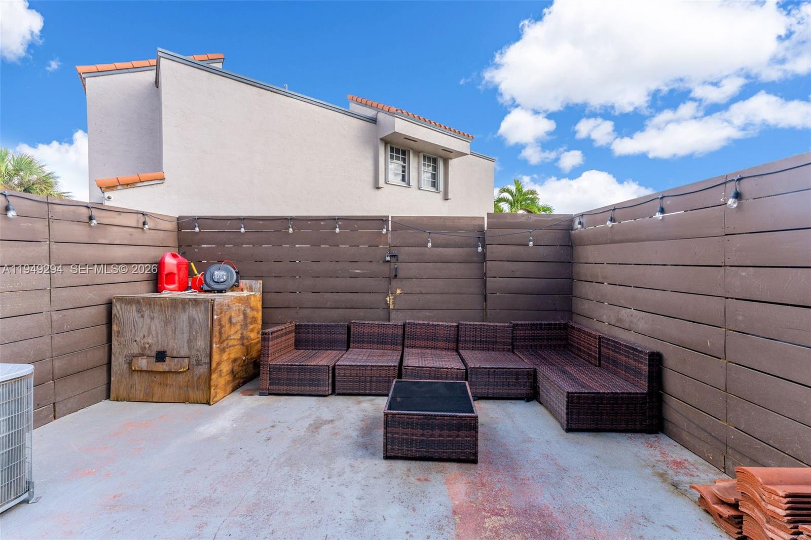 12909 Southwest 64th Lane Miami, FL 33183 - Photo 18 of 35 a wooden bench sitting in front of a building