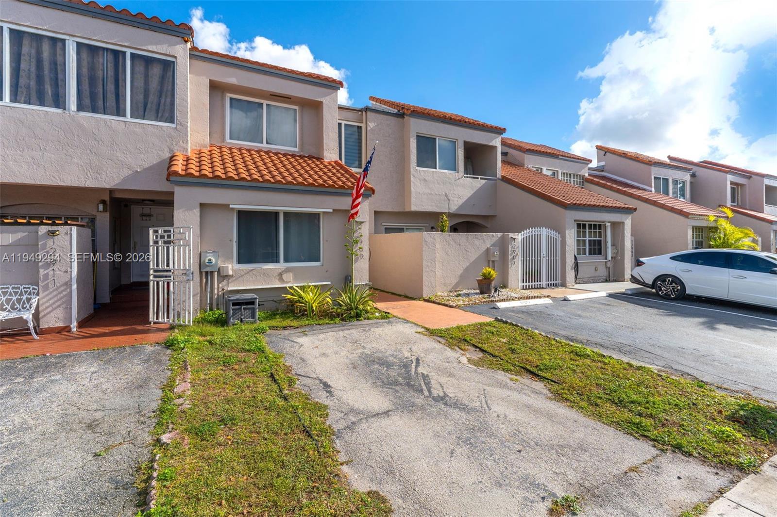 12909 Southwest 64th Lane Miami, FL 33183 - Photo 3 of 35 a front view of a house with a yard