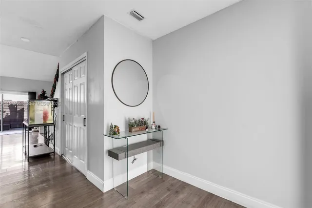 a room with a wooden floor and a mirror