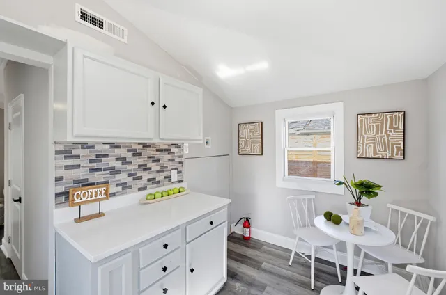 a kitchen with granite countertop a sink and stove