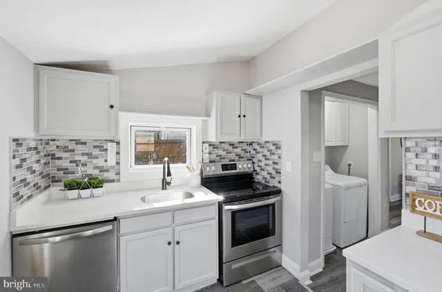 a kitchen with a sink stove and refrigerator