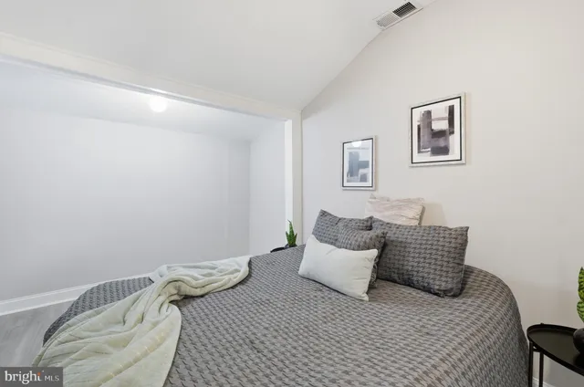 a bedroom with a bed and couch