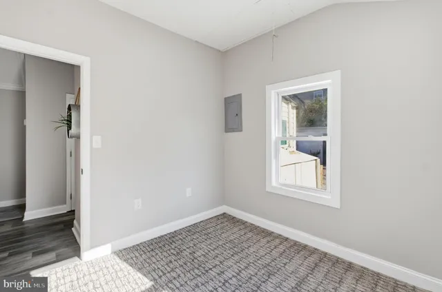 a bathroom with a granite countertop sink a toilet and shower