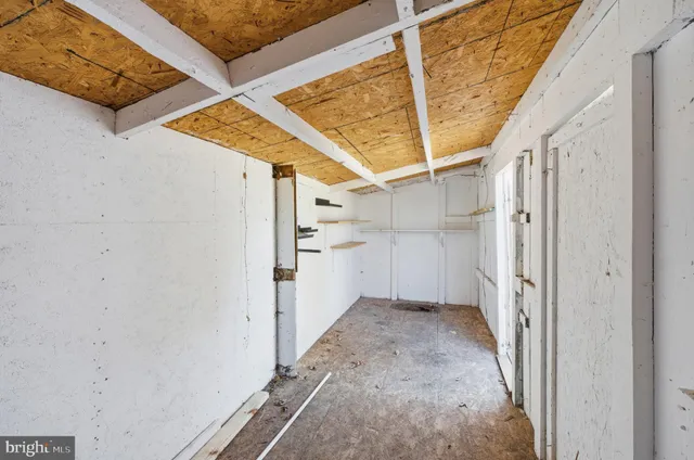 a backyard of a house with barbeque oven and outdoor seating