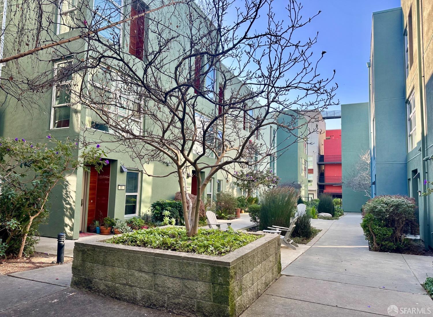 a view of a house with a yard and potted plants