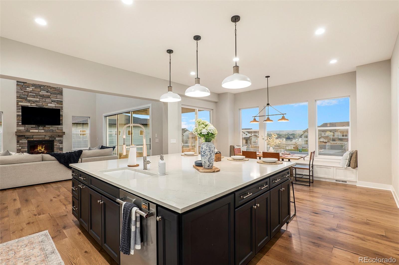 5828 Tesoro Point Parker, CO 80134 - Photo 12 of 43 a kitchen with granite countertop a sink a counter top space and living room view