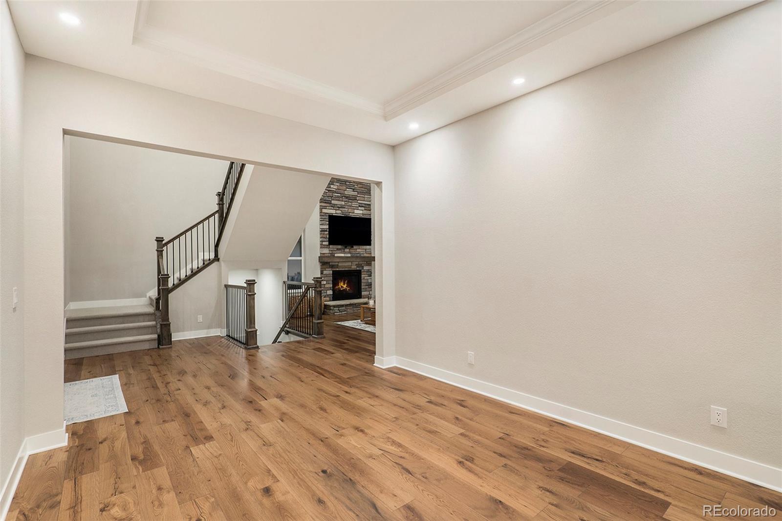5828 Tesoro Point Parker, CO 80134 - Photo 16 of 43 a view of a livingroom with wooden floor and stairs