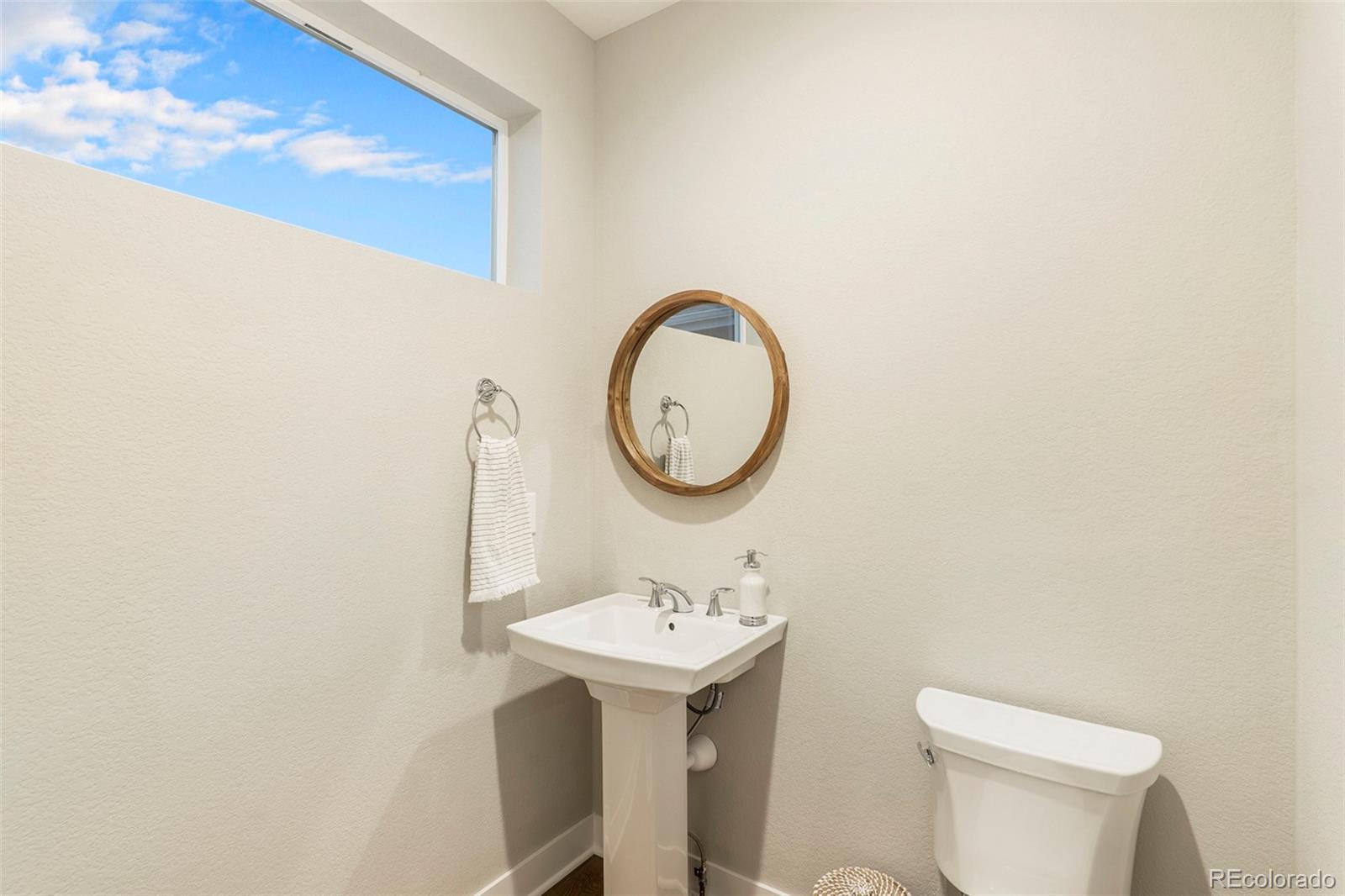 5828 Tesoro Point Parker, CO 80134 - Photo 20 of 43 a bathroom with a sink mirror and toilet
