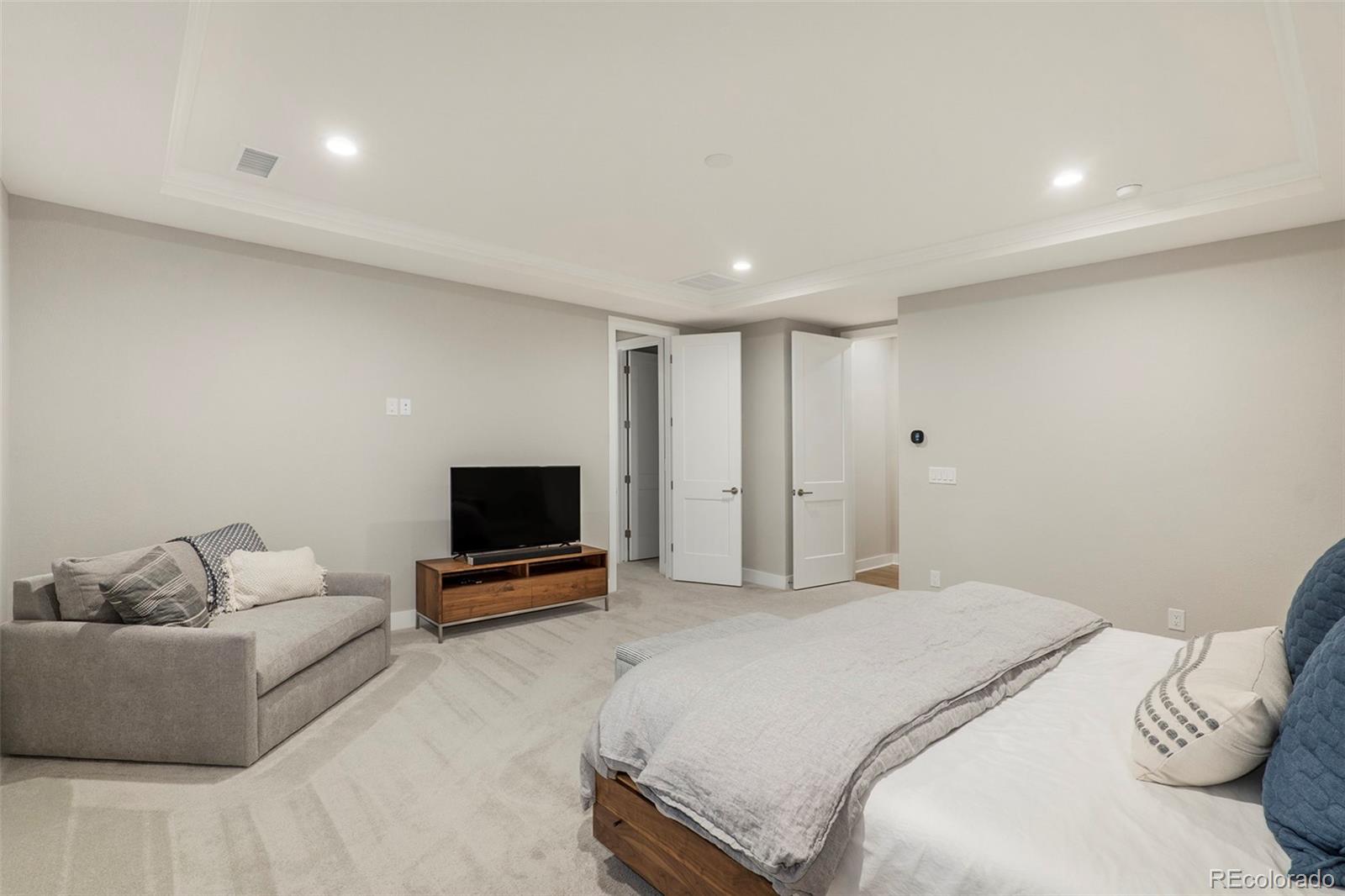 5828 Tesoro Point Parker, CO 80134 - Photo 25 of 43 a bedroom with a bed and a flat screen tv