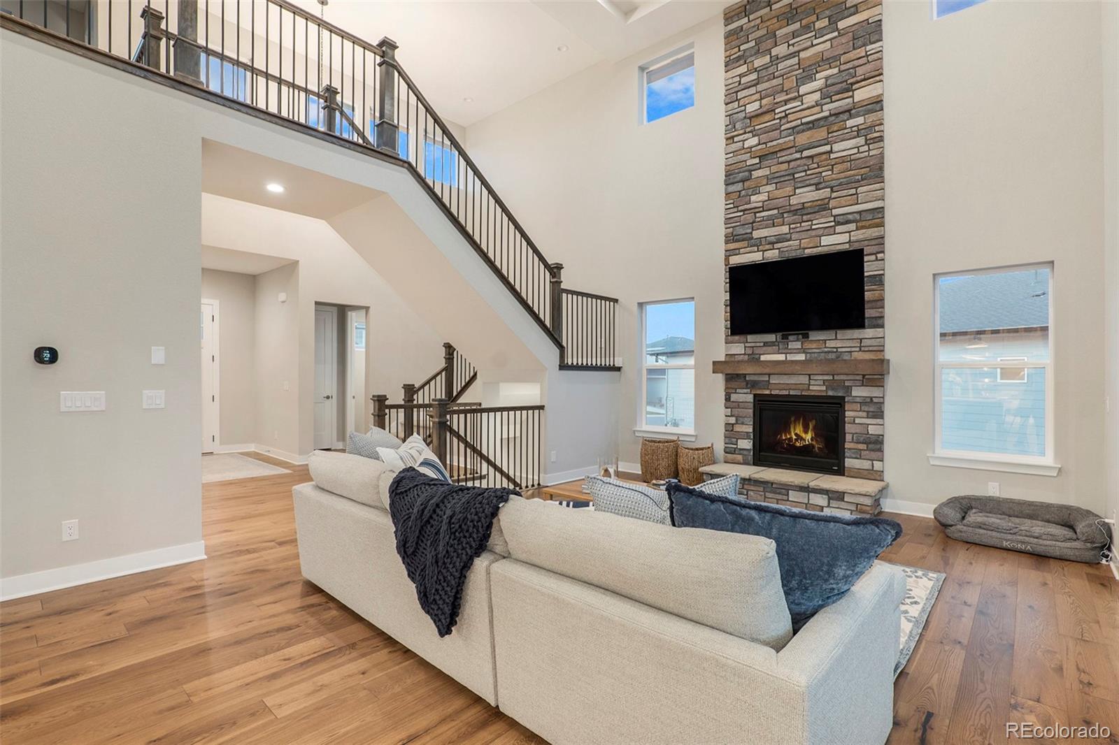 5828 Tesoro Point Parker, CO 80134 - Photo 8 of 43 a living room with furniture fireplace and flat screen tv