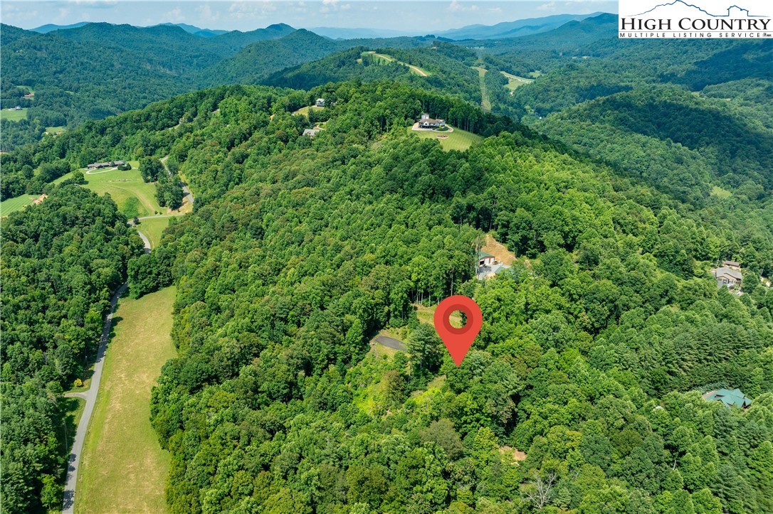 Lot 32 Lake Ridge Butler, TN 37640 - Photo 7 of 30 a backyard of a house with a yard and outdoor seating