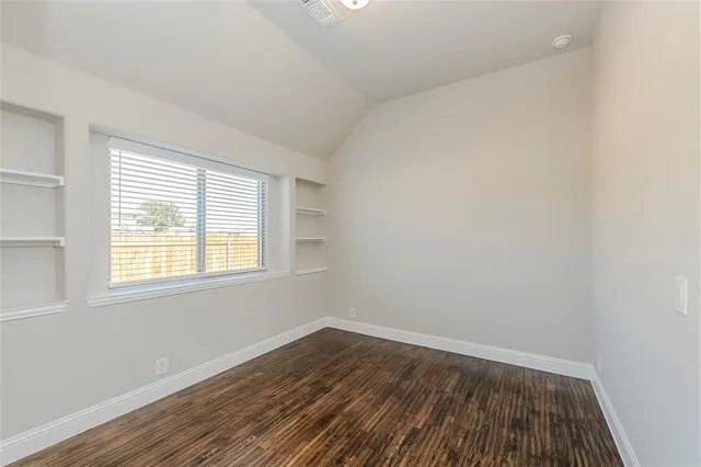 a bathroom with a bathtub shower sink vanity mirror and toilet