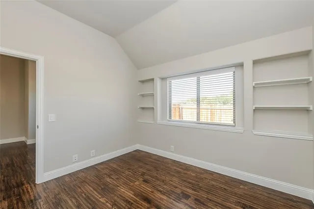 a view of a yard with wooden fence