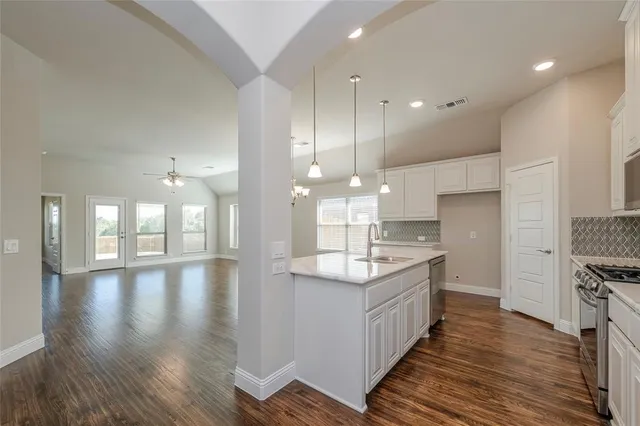 a kitchen with a sink stove and microwave