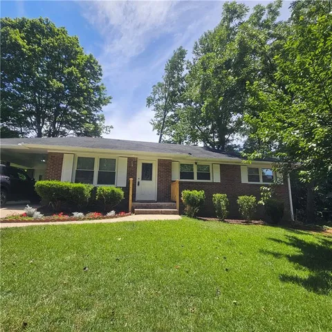 a front view of house with a garden and patio