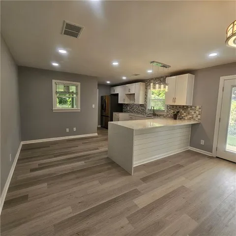a view of kitchen with cabinets and wooden floor