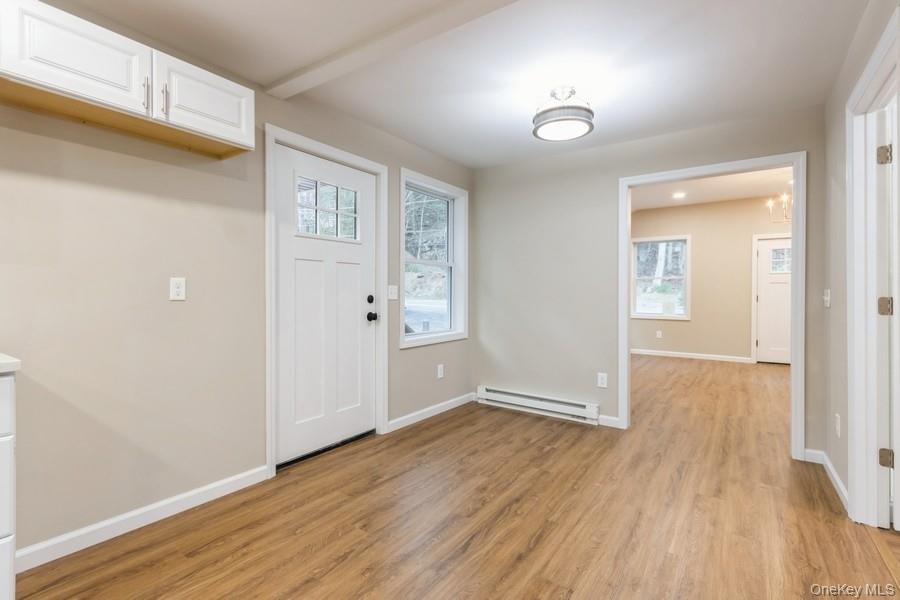 435 State Rte 55 Eldred, NY 12732 - Photo 14 of 26 an empty room with wooden floor and windows