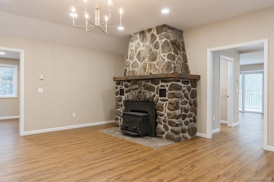 435 State Rte 55 Eldred, NY 12732 - Photo 15 of 26 wooden floor in an empty room with a fireplace