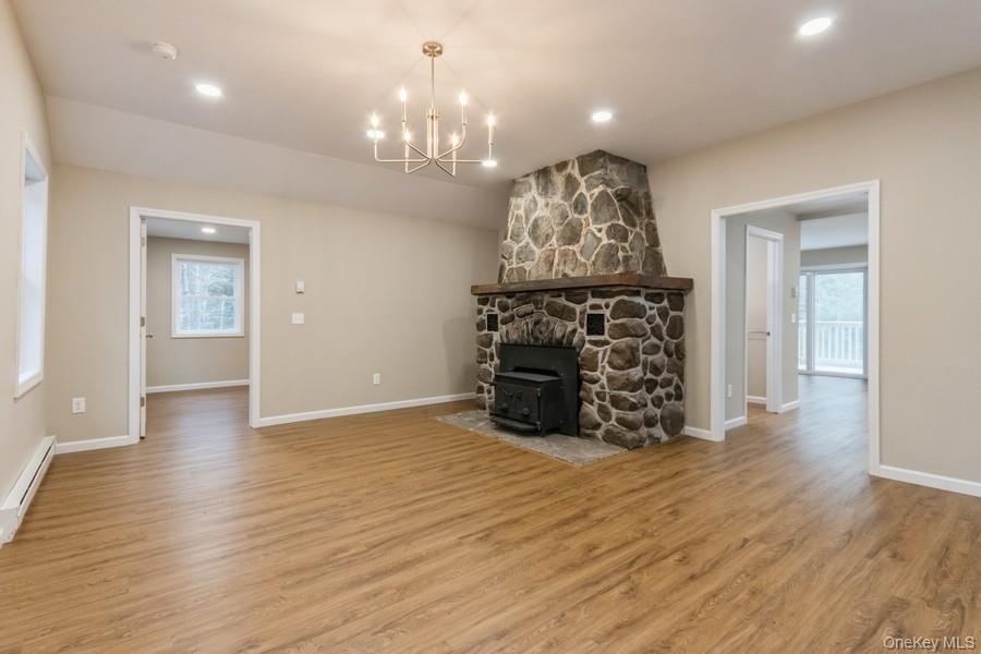 435 State Rte 55 Eldred, NY 12732 - Photo 16 of 26 a view of a big room with wooden floor chandelier and windows