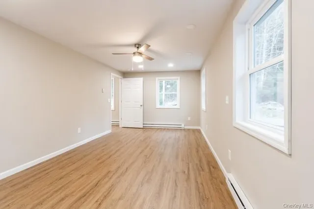 wooden floor in an empty room with a window