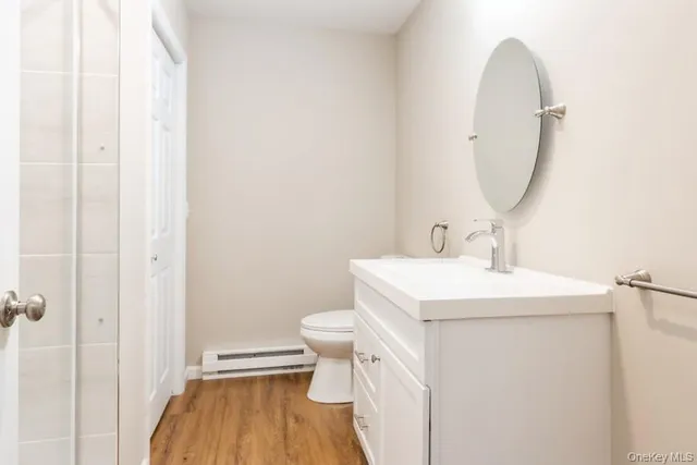 a bathroom with a sink toilet and a mirror