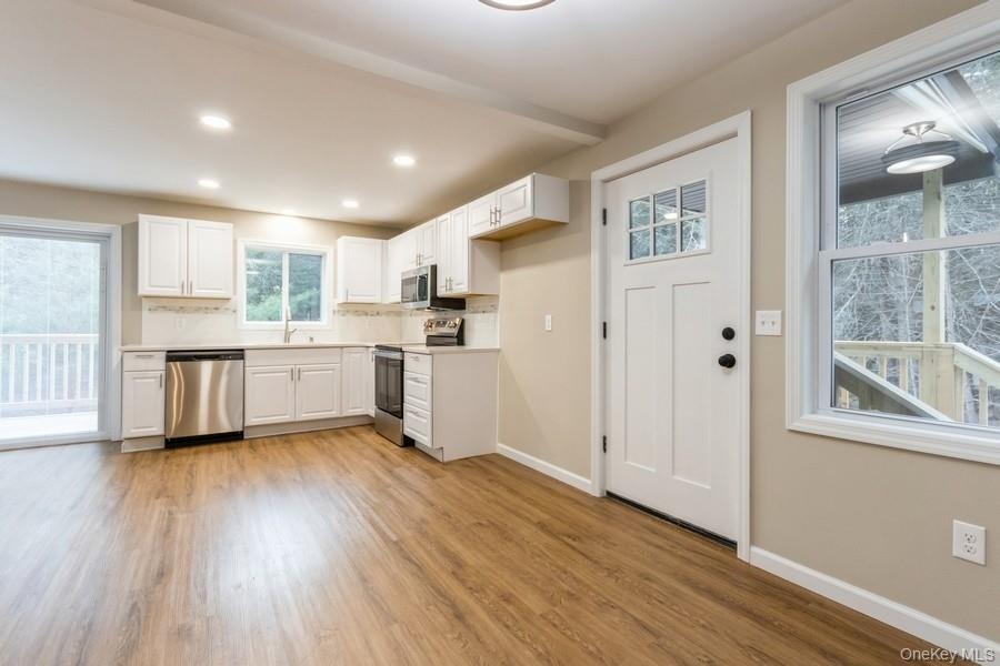 435 State Rte 55 Eldred, NY 12732 - Photo 9 of 26 a view of kitchen with wooden floor and electronic appliances