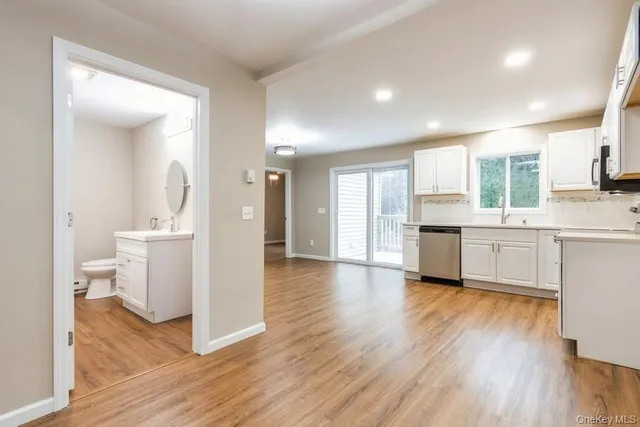 a view of a kitchen cabinets and wooden floor