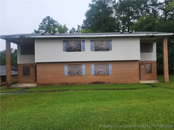 a front view of house with yard and trees