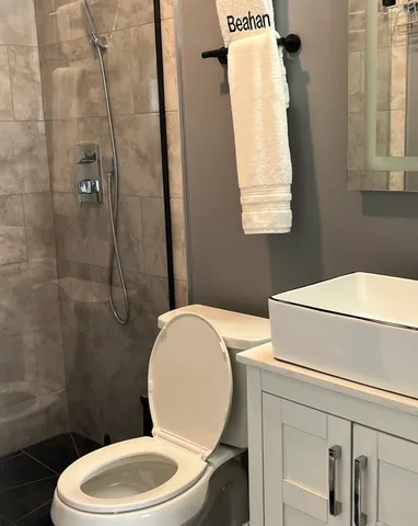 a white toilet sitting next to a bathroom sink