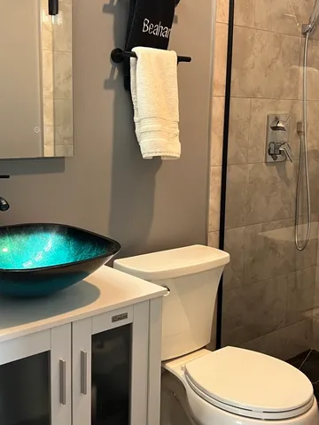 a bathroom with a toilet a sink and a mirror