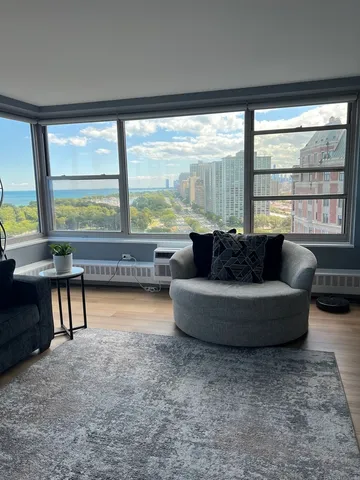 a living room with furniture and a large window