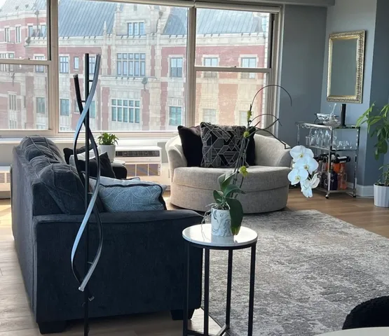 a living room with furniture and a large window