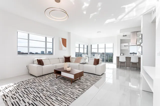 a bedroom with furniture and a large window