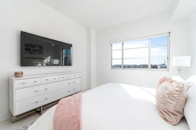 a bedroom with a bed and a flat screen tv