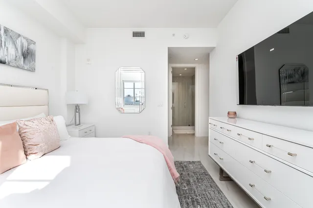 a bedroom with a bed and a dresser